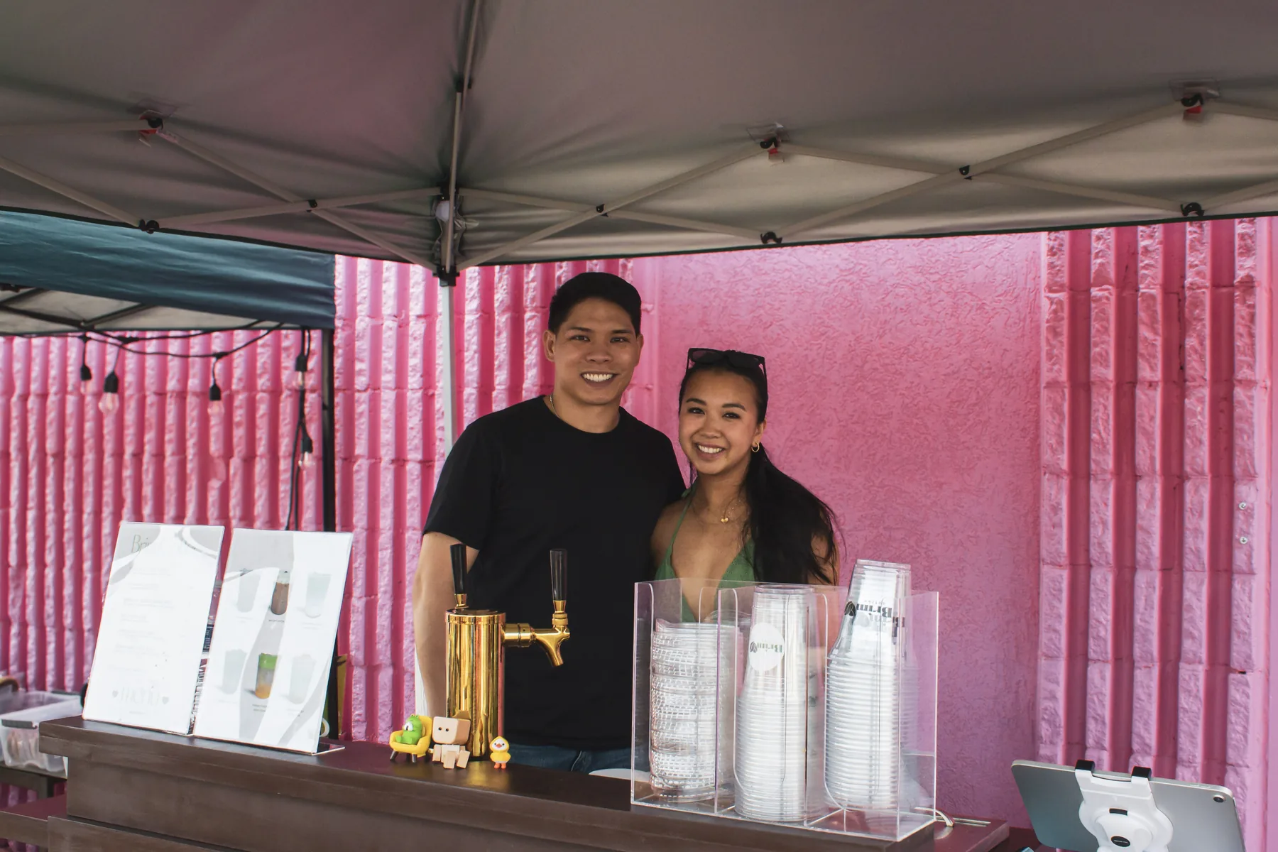 Brim Coffee founders standing behind their booth at a Richmond pop-up
